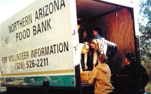Volunteers help unload fresh produce and cans from the back of a Northern Arizona Food Bank truck. Photo courtesy of Northern Arizona Food Bank