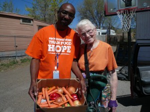 A volunteer at St. Mary’s Food Bank Alliance carries out a box of produce. St. Mary’s reports it distributes more than 12 million pounds of food in Northern Arizona. Photo courtesy of St. Mary’s Food Bank Alliance