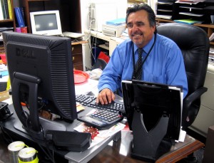 Principal Joe Gutierrez takes a short break from the open house to respond to  an urgent email. Photo by Frank X. Moraga / AmigosNAZ