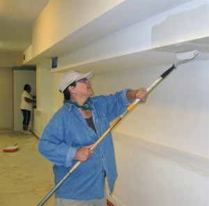 Delia Munoz of Flagstaff Nuestras Raíces puts on the first coat of paint in the basement of Our Lady of Guadalupe in Flagstaff. The group is seeking to work with other service, religious and community organizations to renovate the facility and turn it into a cultural center. Photo by Frank X. Moraga / AmigosNAZ