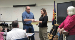 A student receives a graduation certificate from the “Basic Business Empowerment” program. Courtesy image