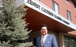 Ernest Calderón stands in front of the residence hall and learning community now named in his honor. Photo courtesy of Northern Arizona University.