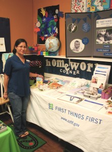 Cynthia M. Pardo, community outreach liaison for First Things First, displays items at her information table during the “Back to School Fair” held on July 19 at the Flagstaff Family Food Center.