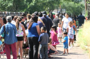 Parents and their children line up in the alley leading to the Flagstaff Family Food Center for the “Back to School Fair” where a total of 634 backpacks were given away on July 19, with an additional 250 given away later that week.