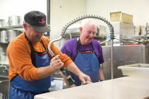 Curt Knight and David Downes are busy in the kitchen prior the opening of that evening’s hot meal session.