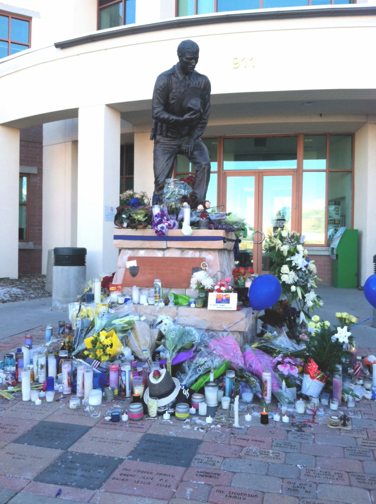 Flowers, candles and cards have been placed at the Police Officers Memorial in honor of fallen Officer Tyler Jacob Stewart. Photo by Frank X. Moraga : AmigosNAZ